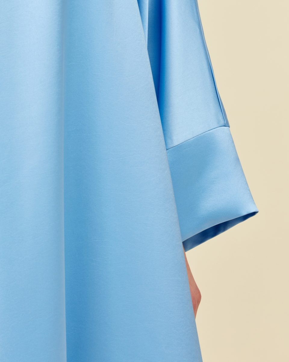 https://www.seamehappy.be/wp-content/uploads/2023/01/Sea-Me-Happy-Soraya-Dress-Satin-light-blue-closeup2-960x1200.jpg